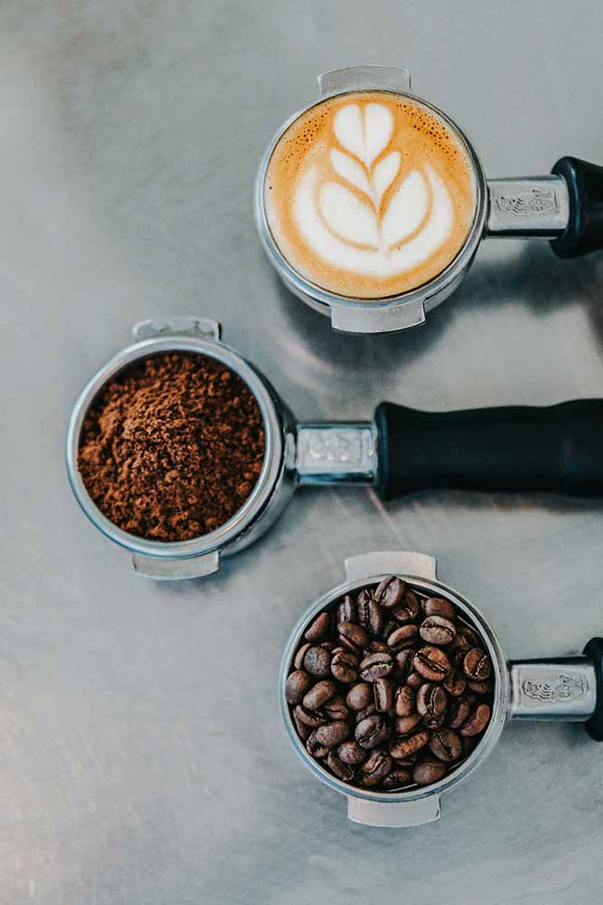 Coffee, portafilters with espresso, ground coffee and beans