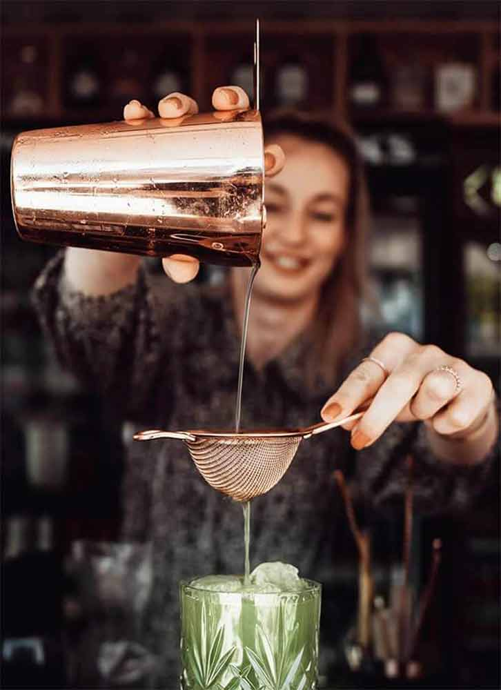 Bartender pouring cocktail